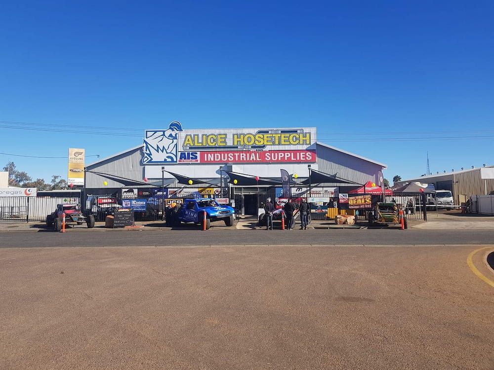 A Large Building With Vehicles — AHT Towing in Ciccone, NT