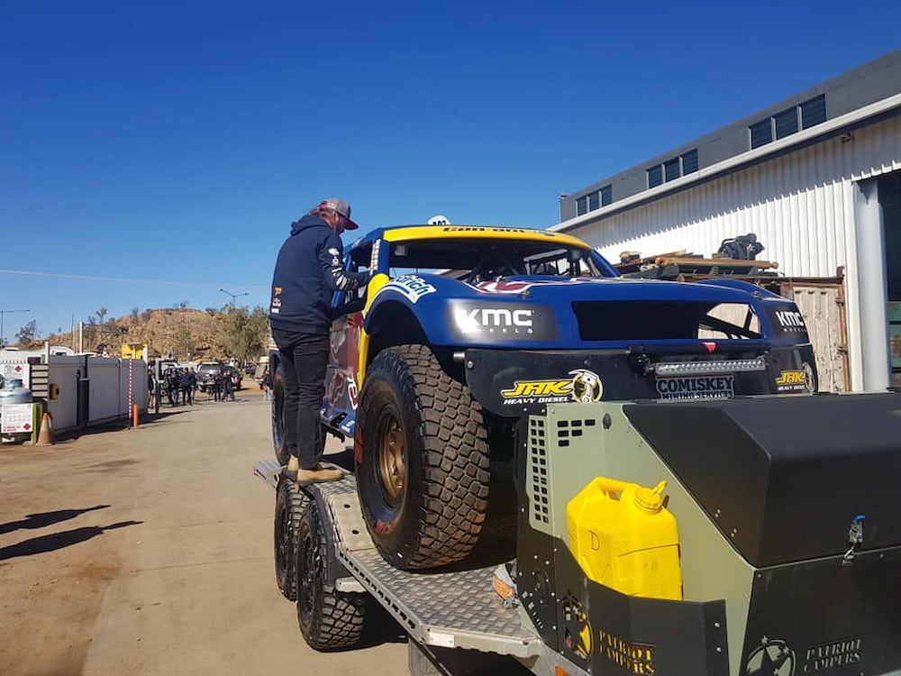 A Blue And Yellow Race Car Is On A Trailer — AHT Towing in Ciccone, NT