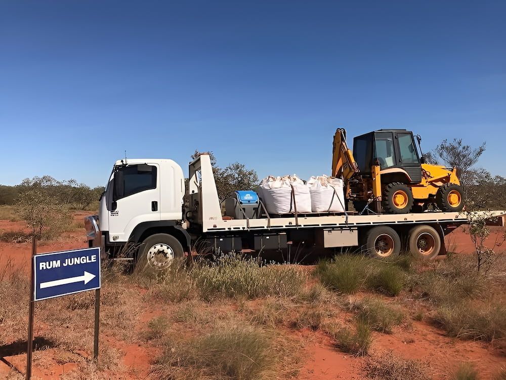 A White Truck With A Yellow Excavator — AHT Towing in Ciccone, NT