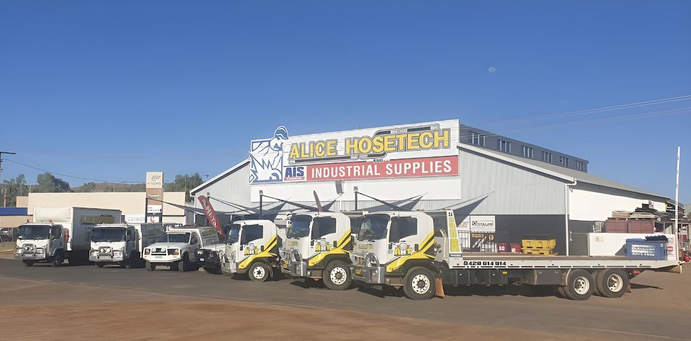 A Row Of Trucks Are Parked In Front Of A Building — AHT Towing in Ciccone, NT
