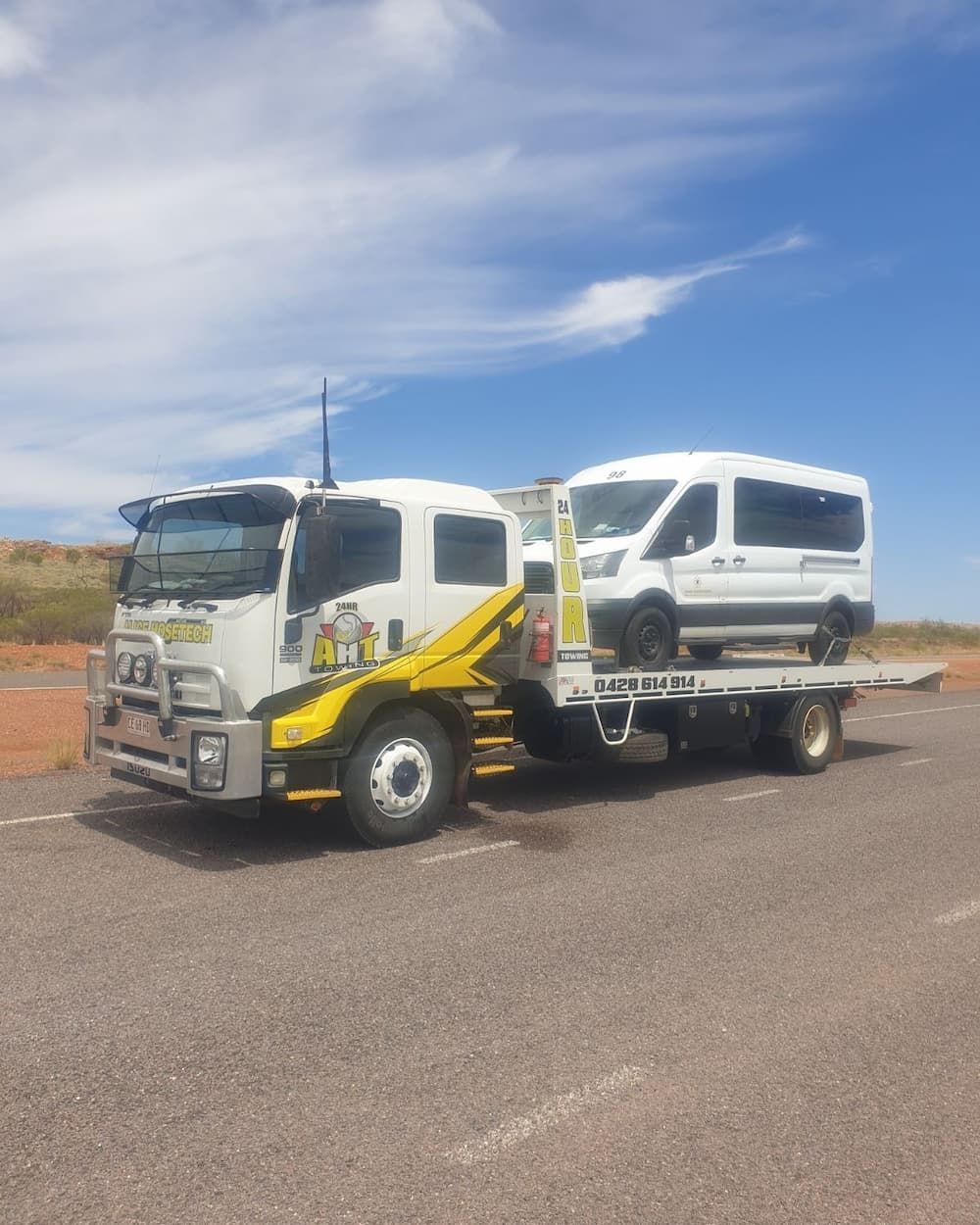 A White and Yellow Tow Truck Carrying a Car