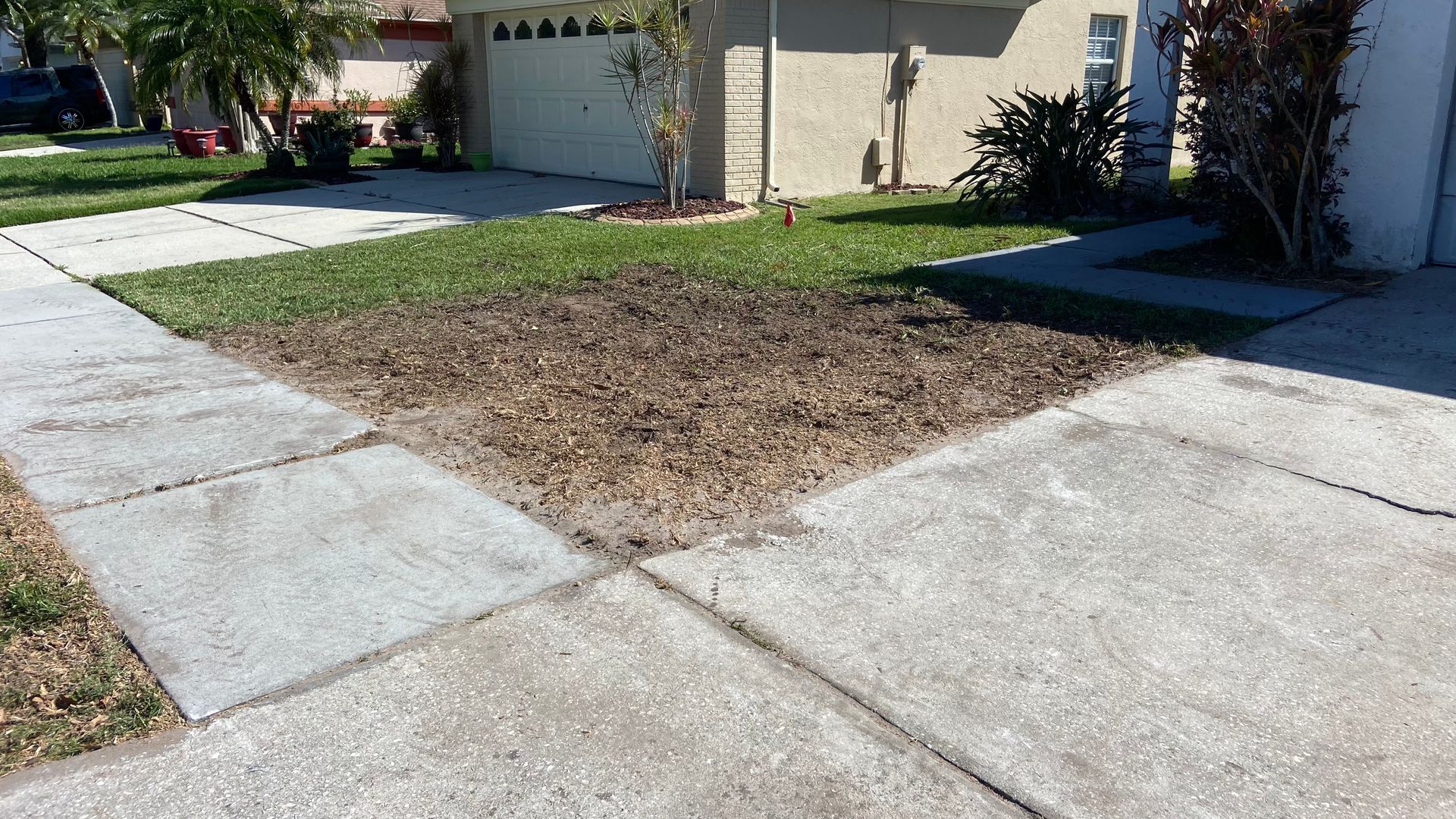 A concrete sidewalk with a grassy area in the middle of it