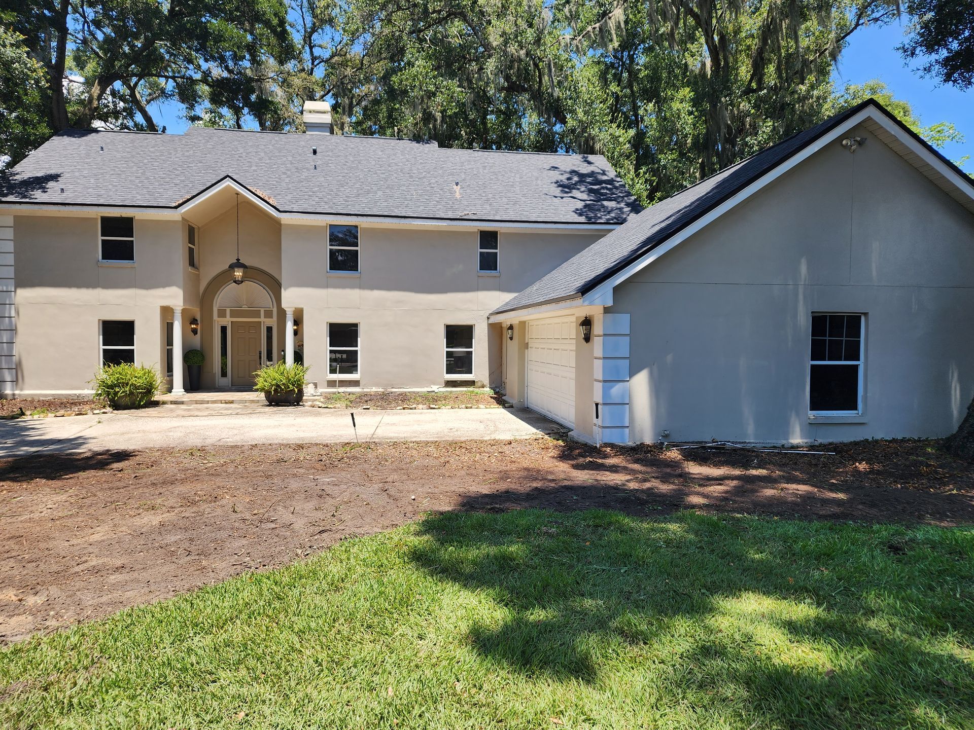 A large house with a lot of windows and a gray roof