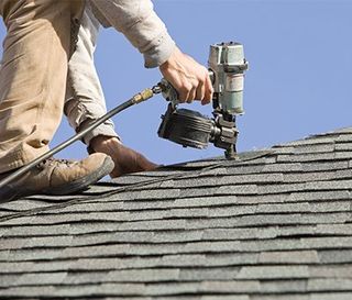 Tile Roof Repairs — Worker Repairs the Roof in Port Richey, FL