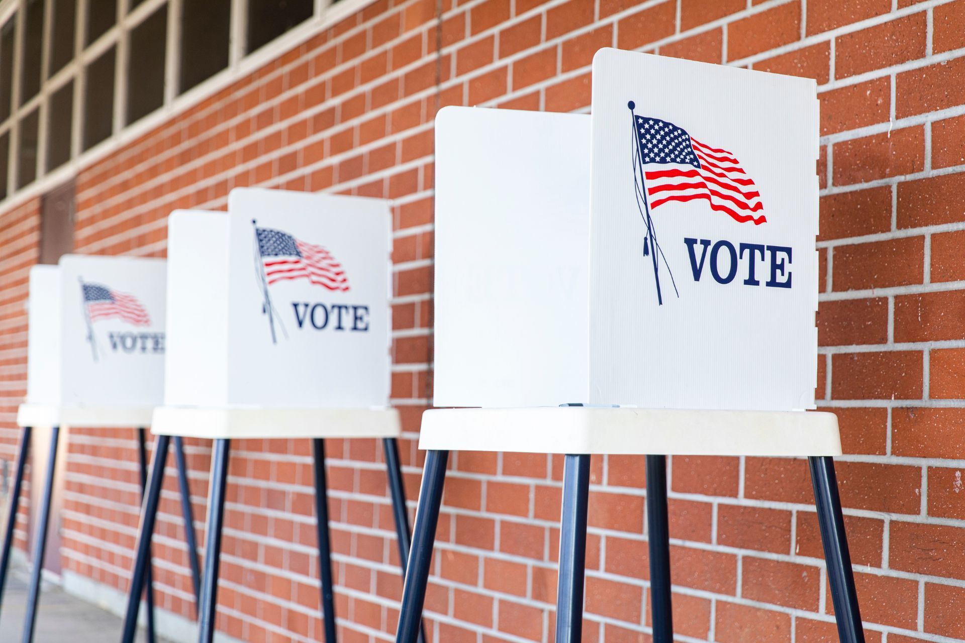 a row of voting booths with the word vote on them