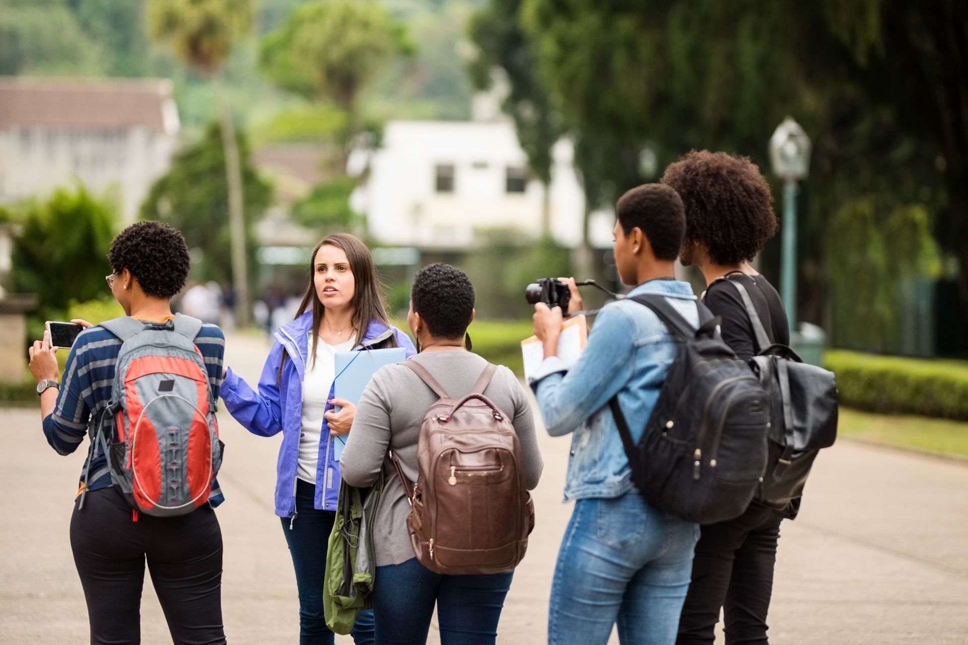 a woman in a blue jacket is leading a Leadership Oak Ridge class tour.