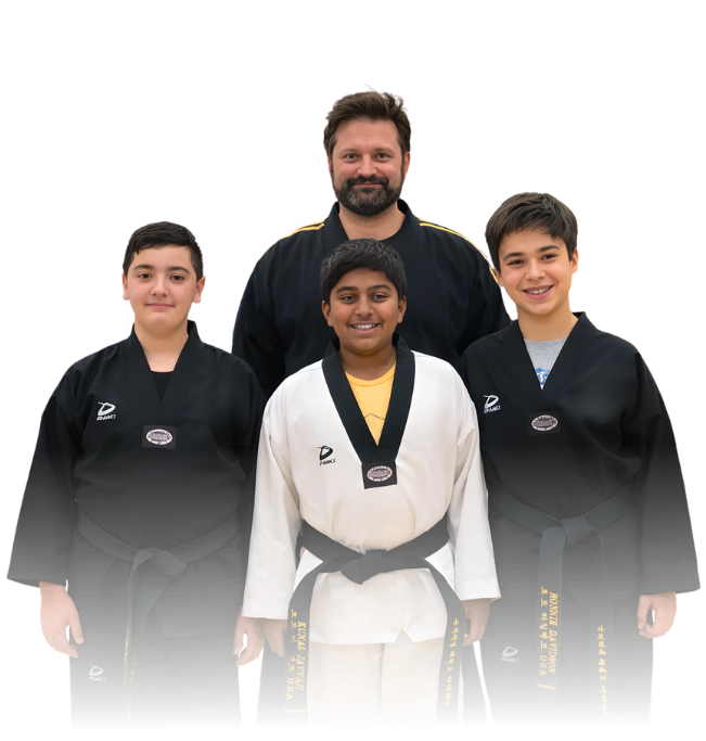 Man pointing, smiling, wearing black hoodie; arm tattoo visible.