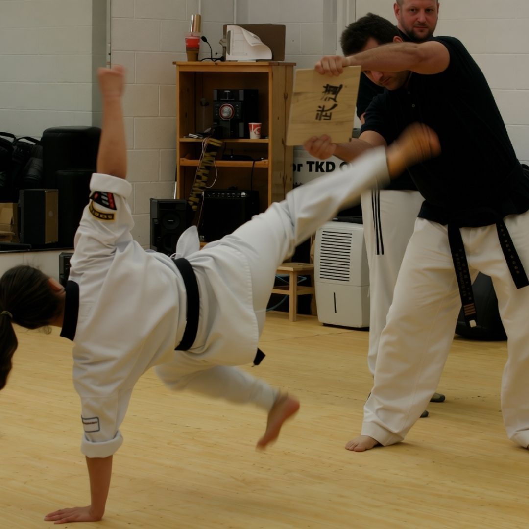 People practicing jiu-jitsu on mats, wearing gis in blue, black, and gray. Active grappling, gym setting.