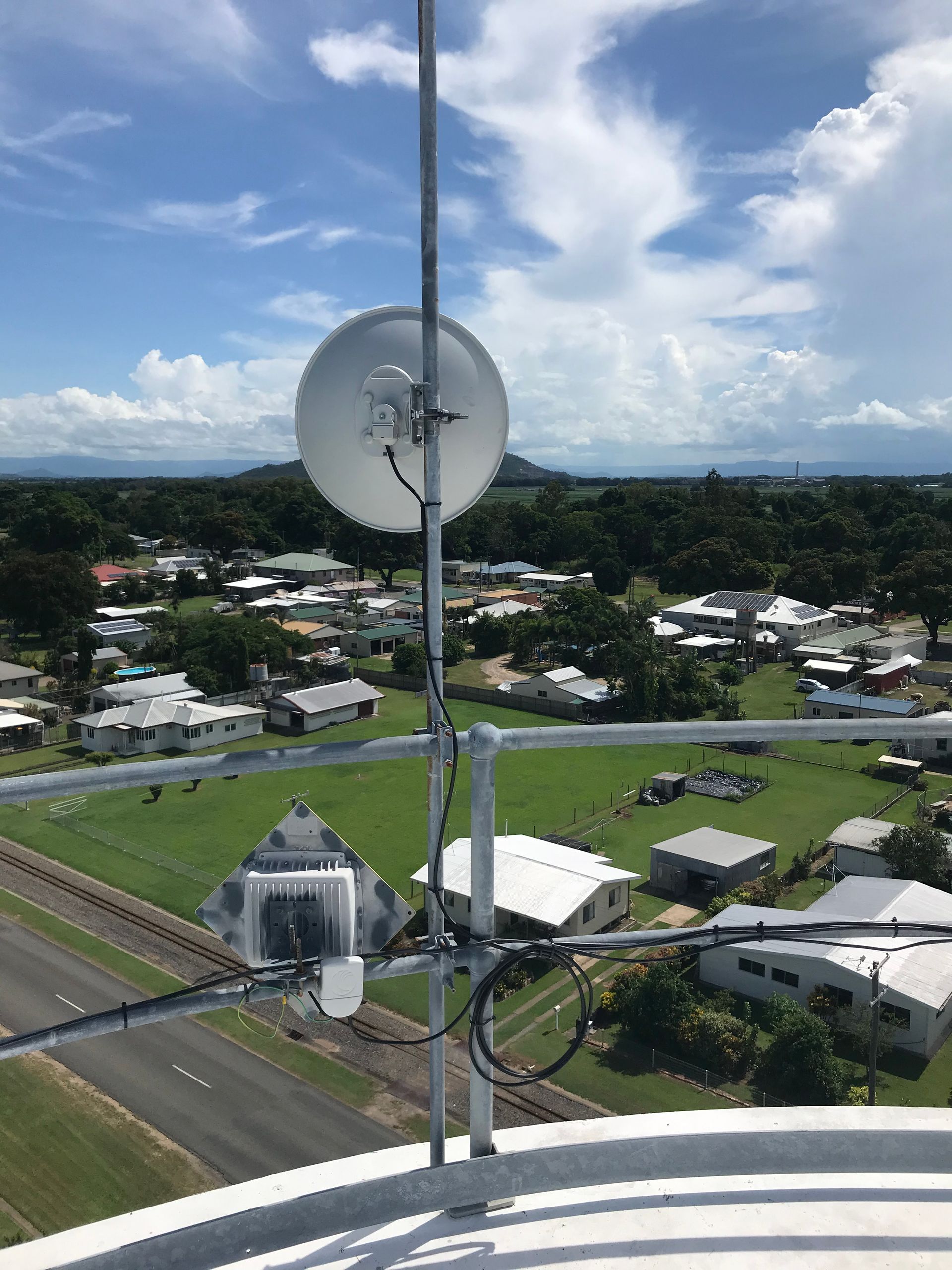 An aerial view of a city with a satellite dish on top of a building.