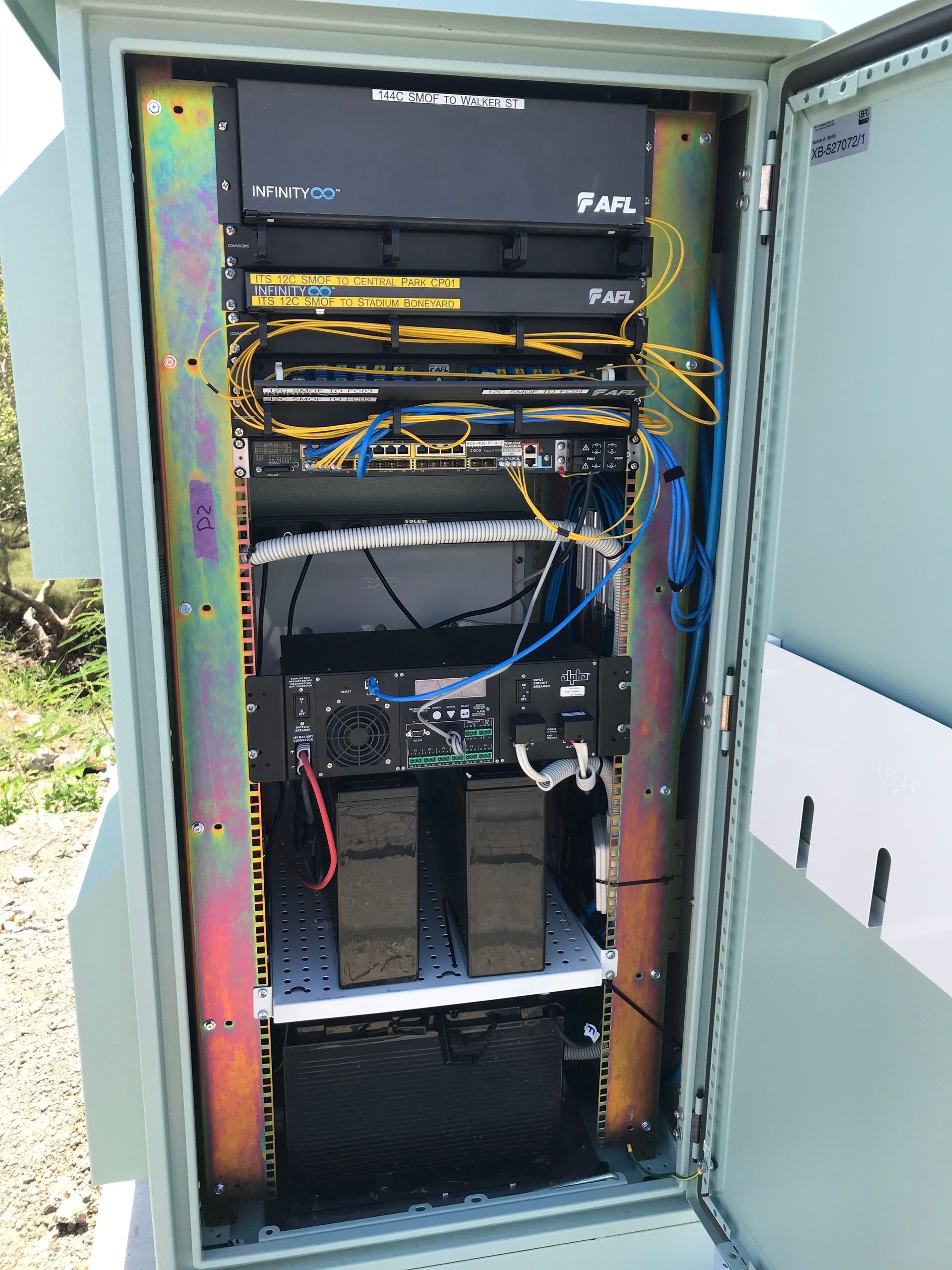 The inside of a server box with a lot of wires coming out of it