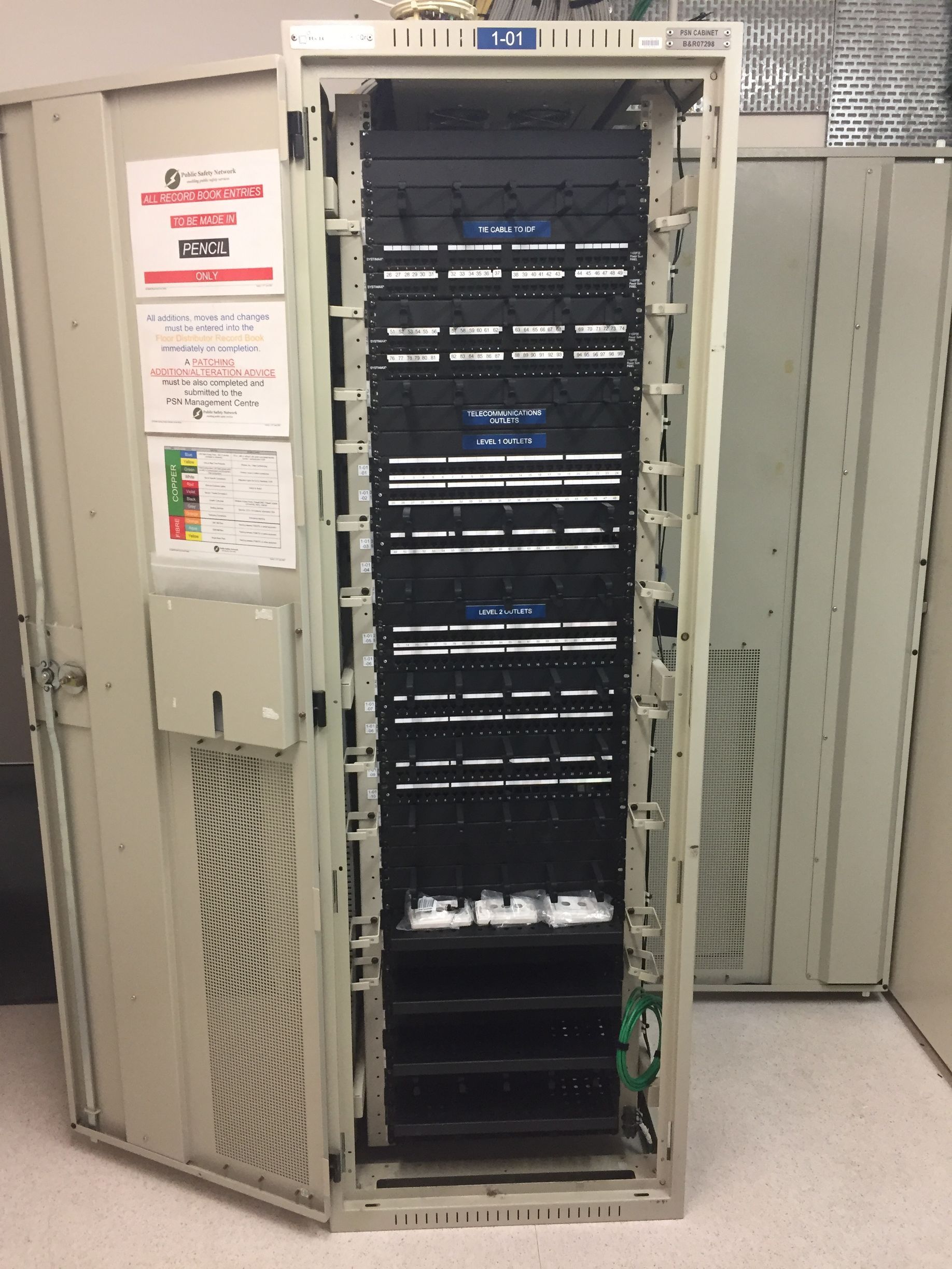 A server rack with a warning sign on it