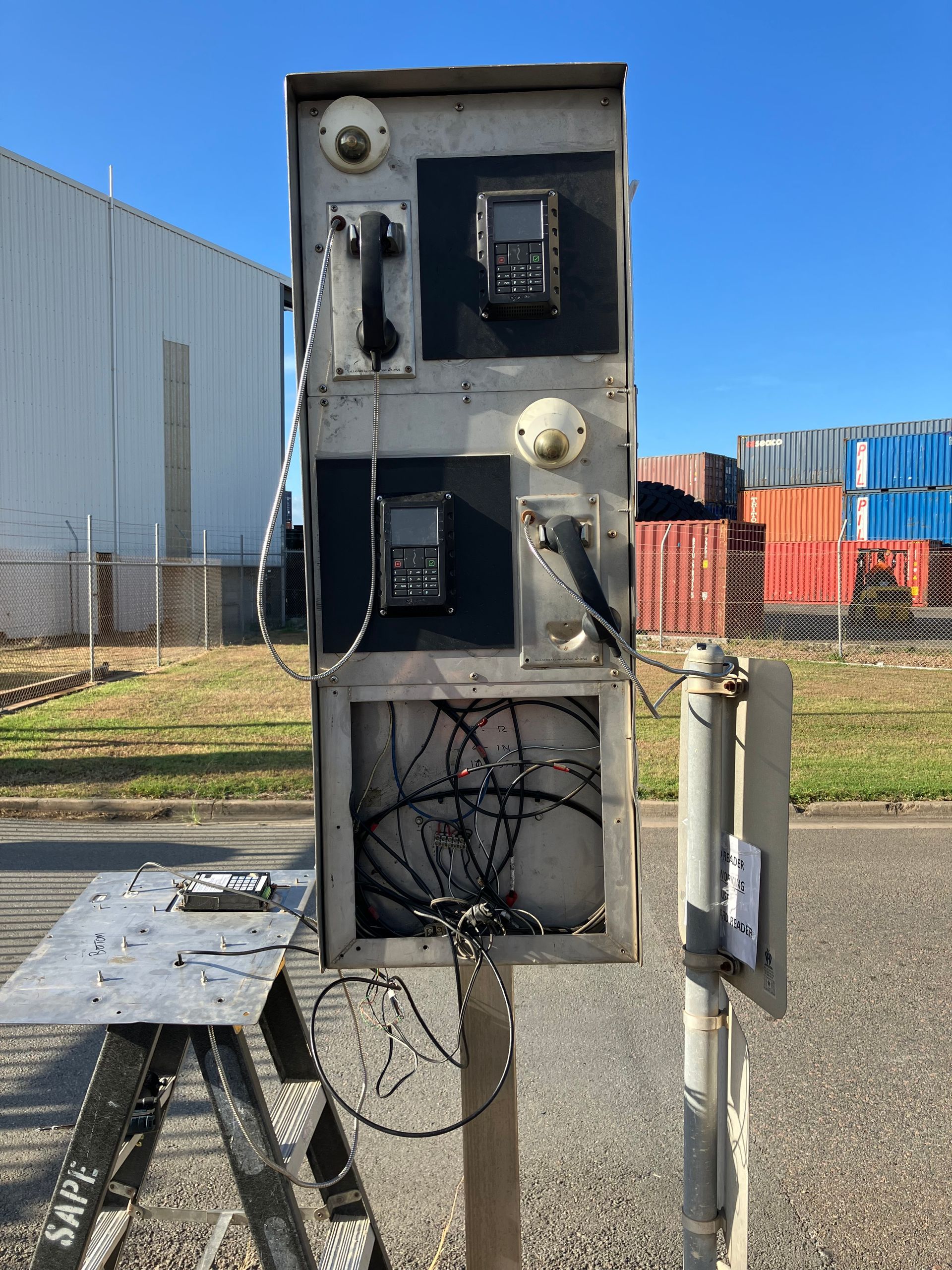 A phone booth is sitting on top of a wooden trestle.