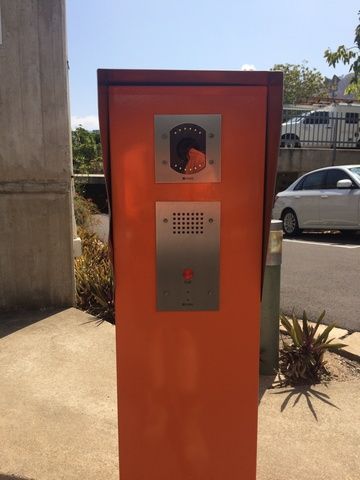 Parking Meter With a White Car Parked Behind It — Sape Industries in Garbutt, QLD