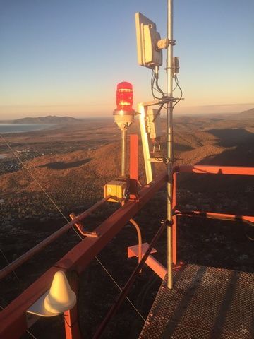 Tower With a Red Light on Top of It Overlooking a Valley — Sape Industries in Garbutt, QLD