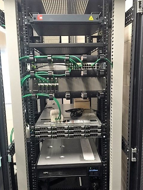 A server rack with a lot of wires coming out of it.
