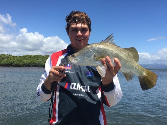 Person Removing Hook From Fish Holding In Hand — Sape Industries in Garbutt, QLD