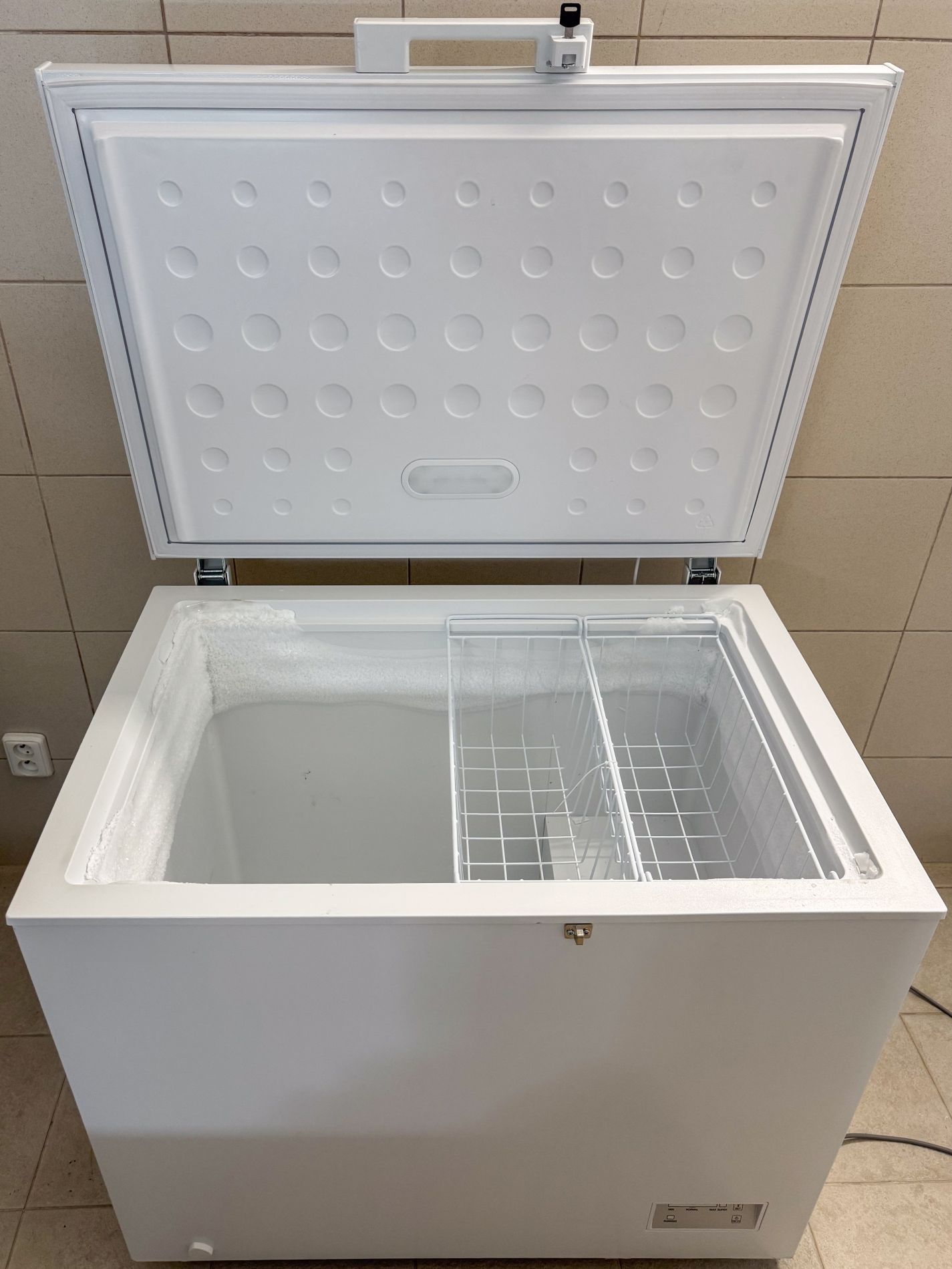 White chest freezer with the lid open.