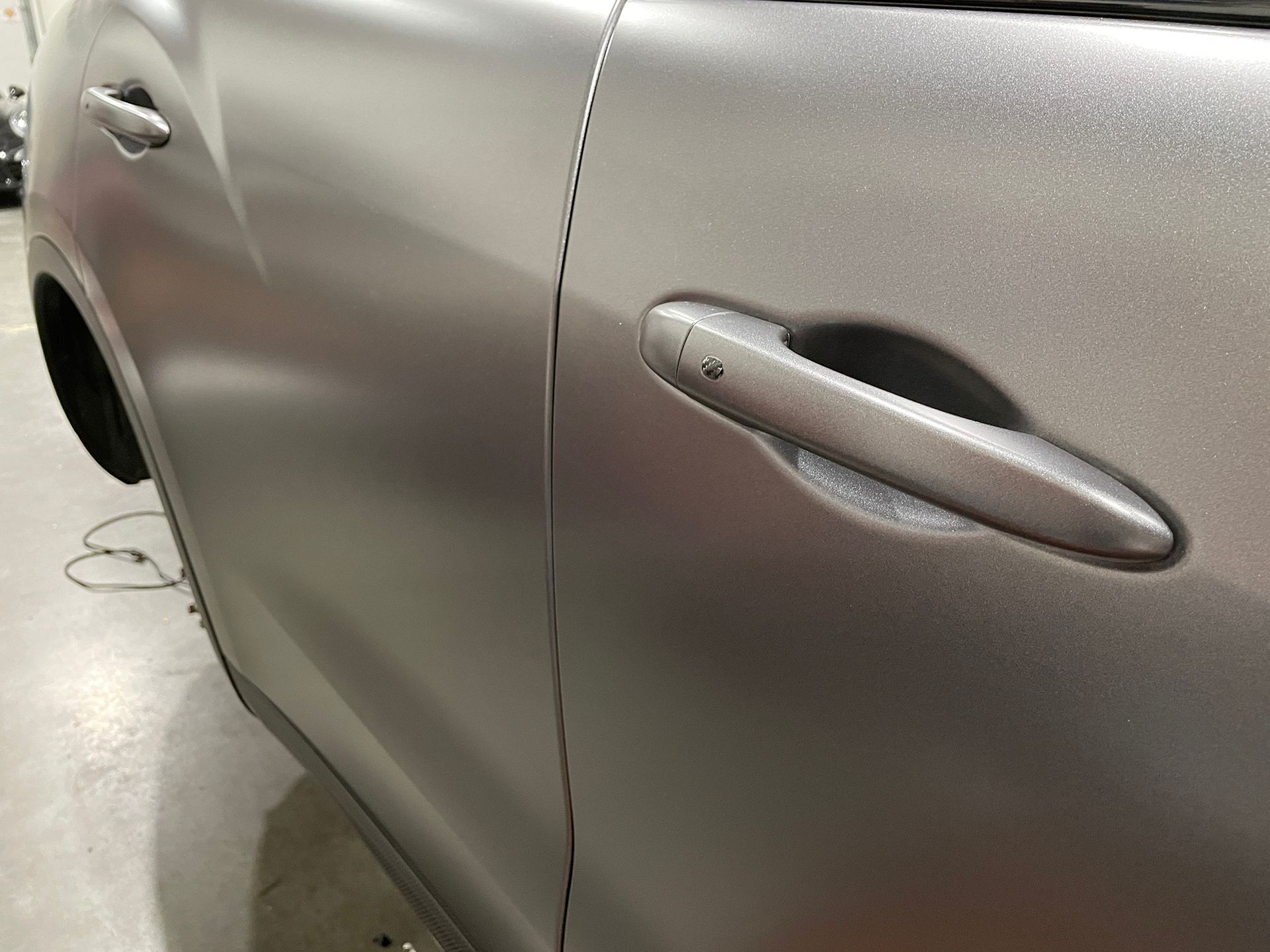 A close up of a silver car 's door handle