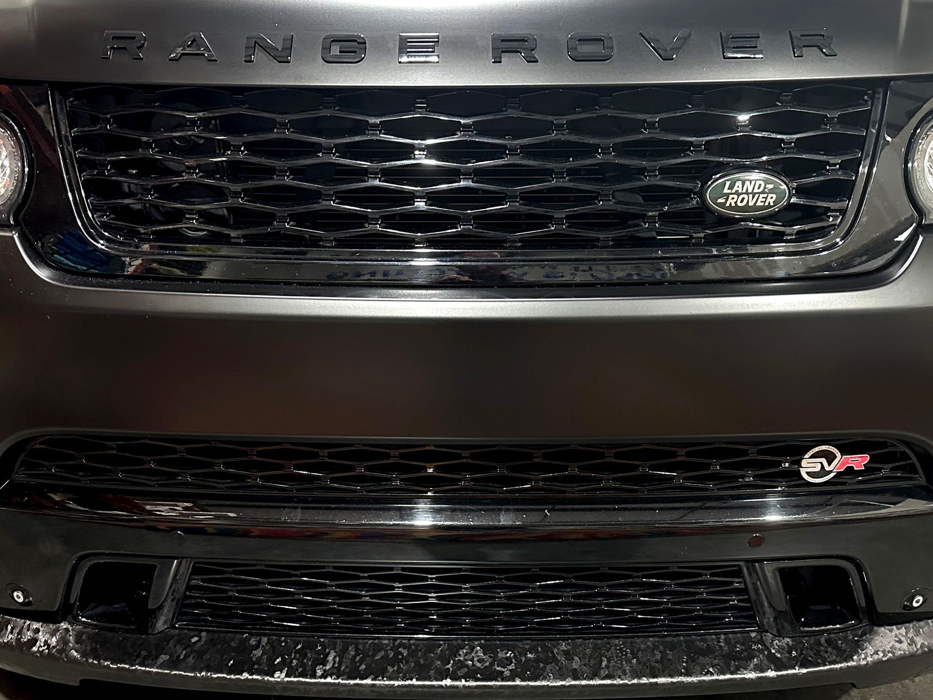A close up of the front of a range rover.