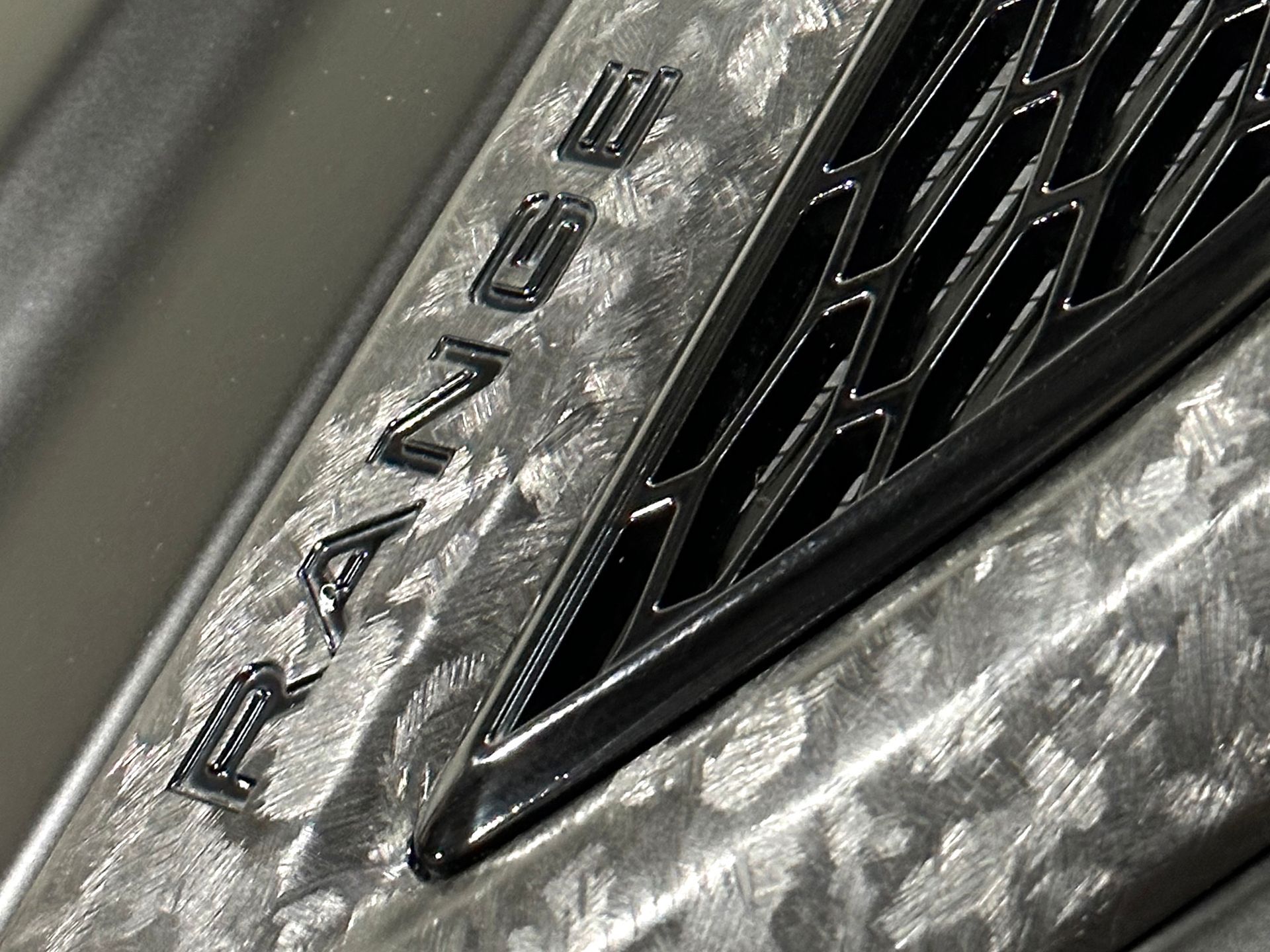 A close up of a range rover logo on the side of a car.