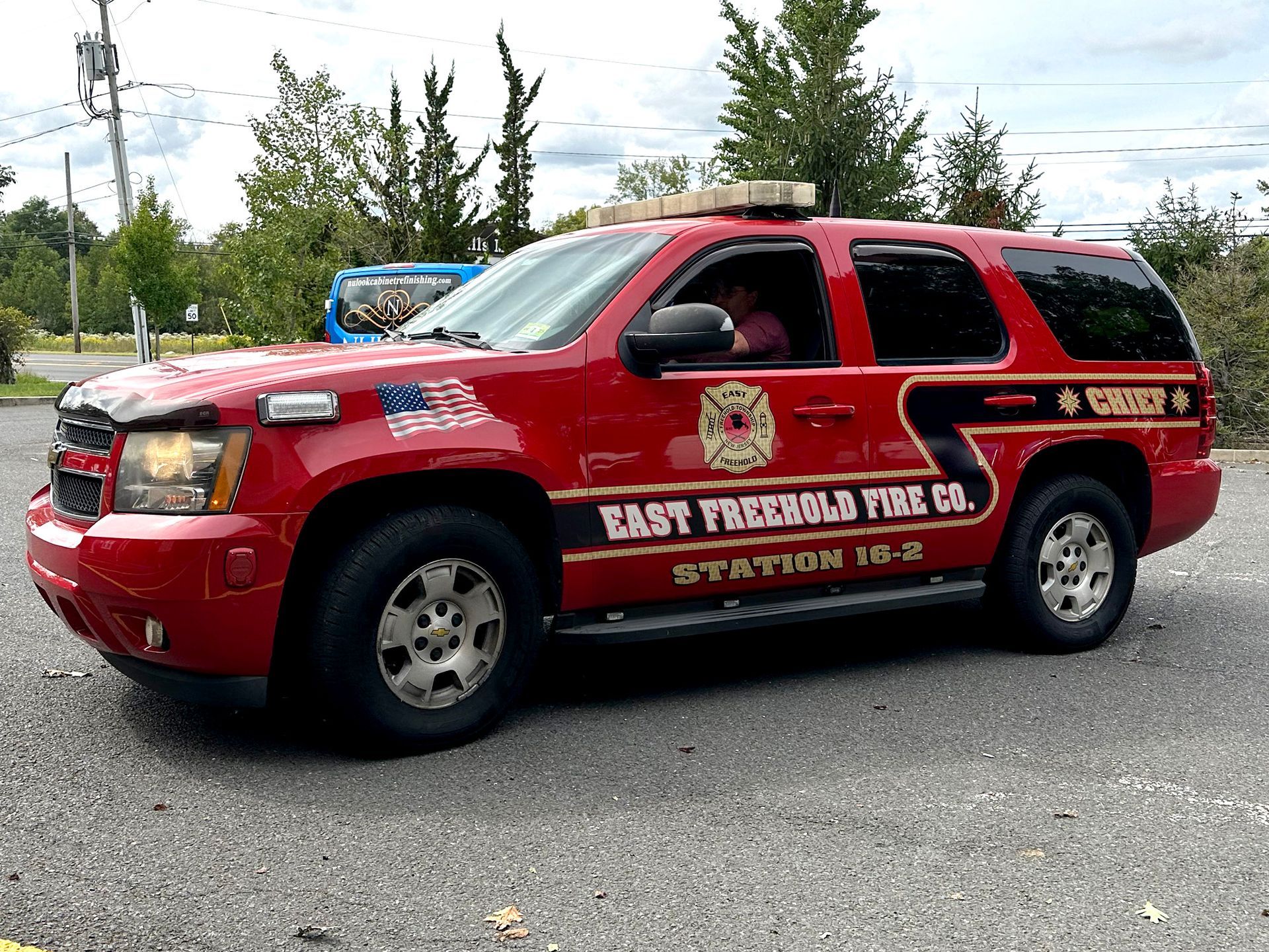 A red fire truck is parked on the side of the road.