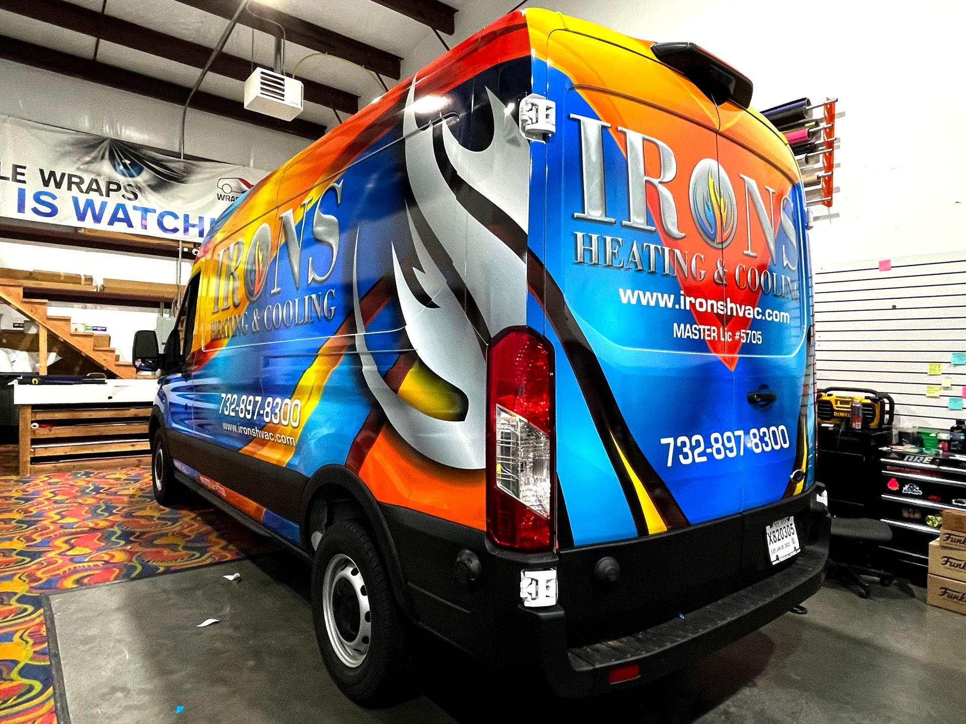 A colorful van with the word iron heating and cooling on it