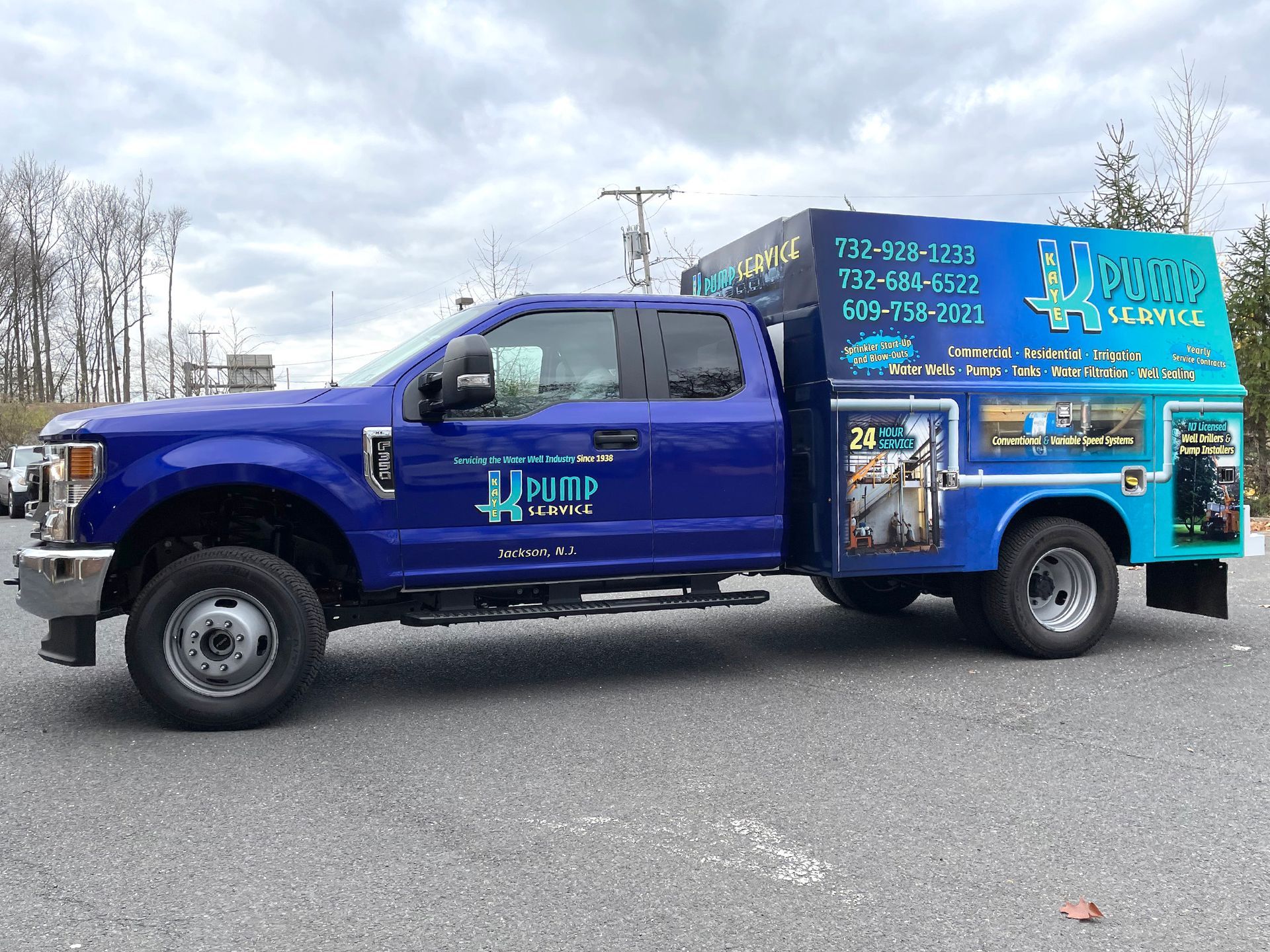 A blue truck is parked on the side of the road.