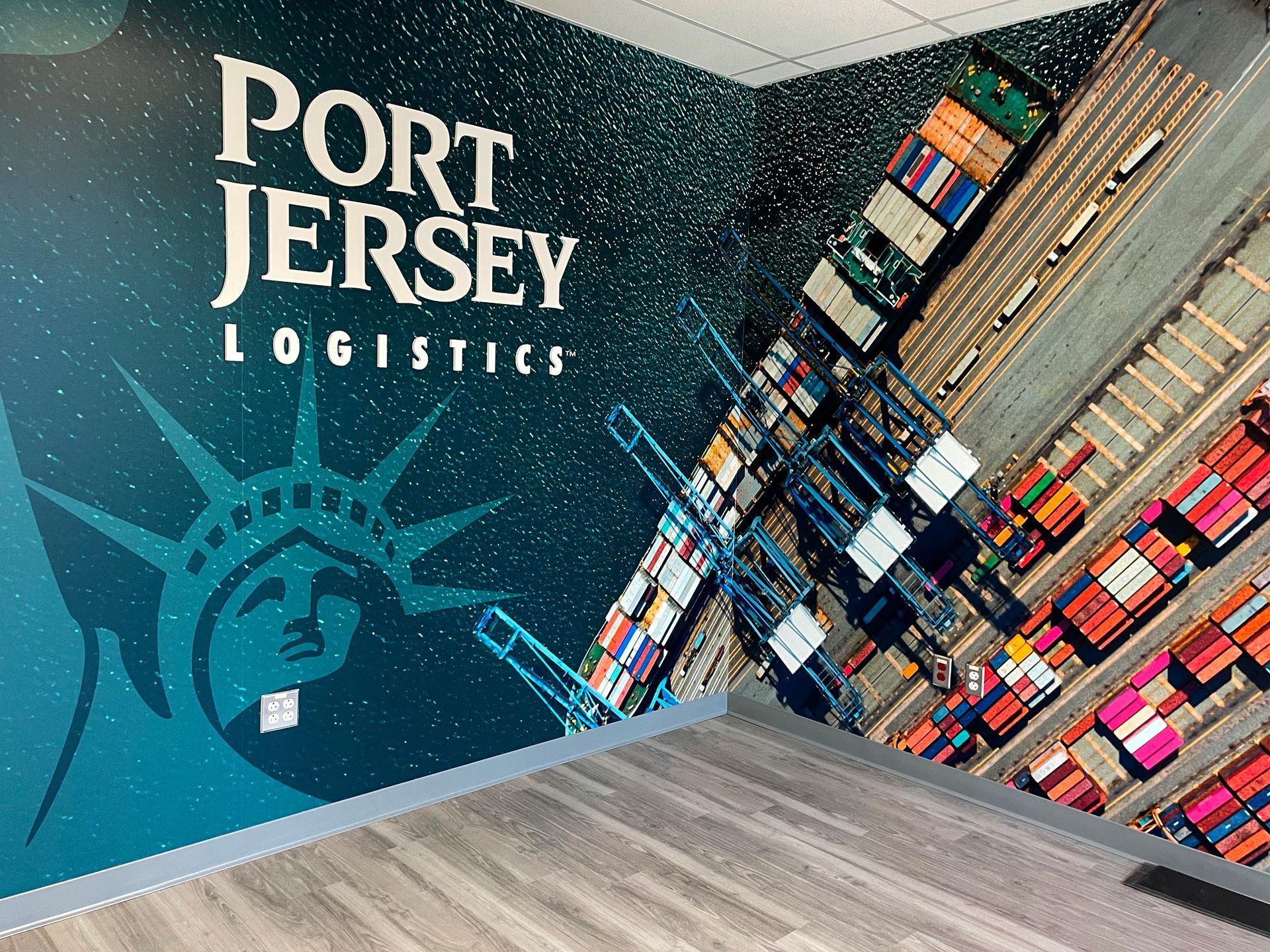 A wall with a picture of the statue of liberty and the words port jersey logistics