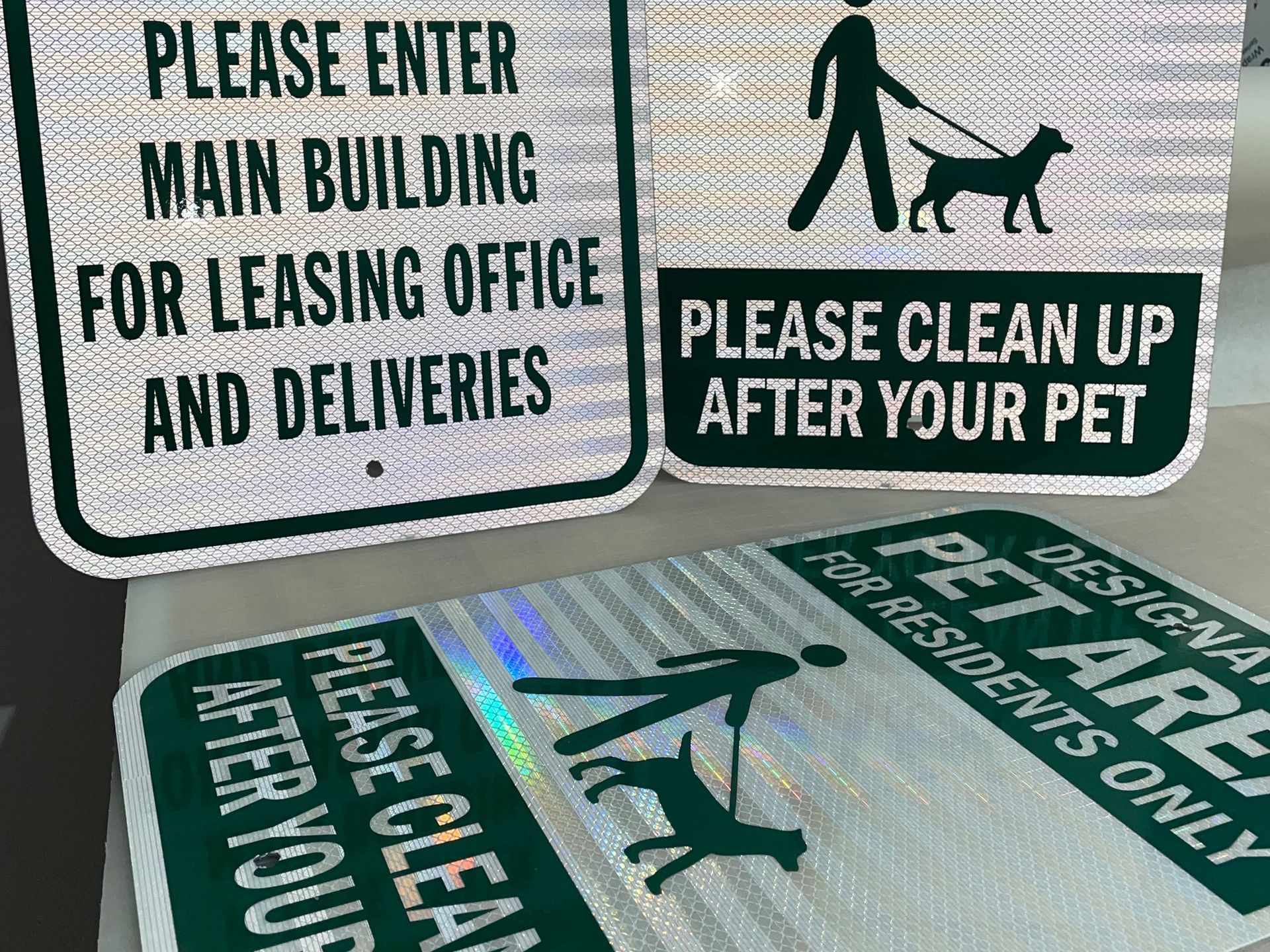 A couple of signs that say please clean up after your pet