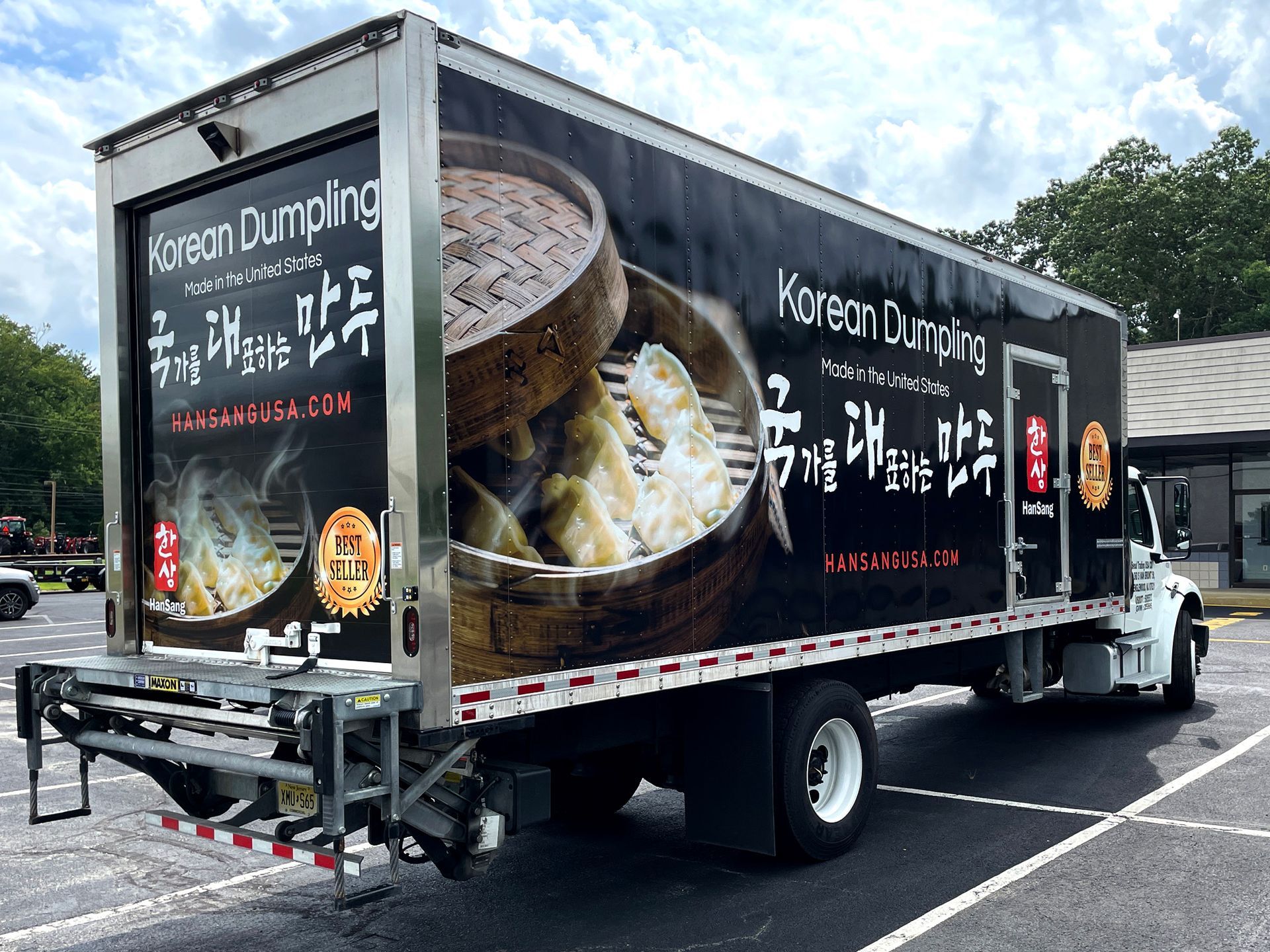 A korean dumpling truck is parked in a parking lot.