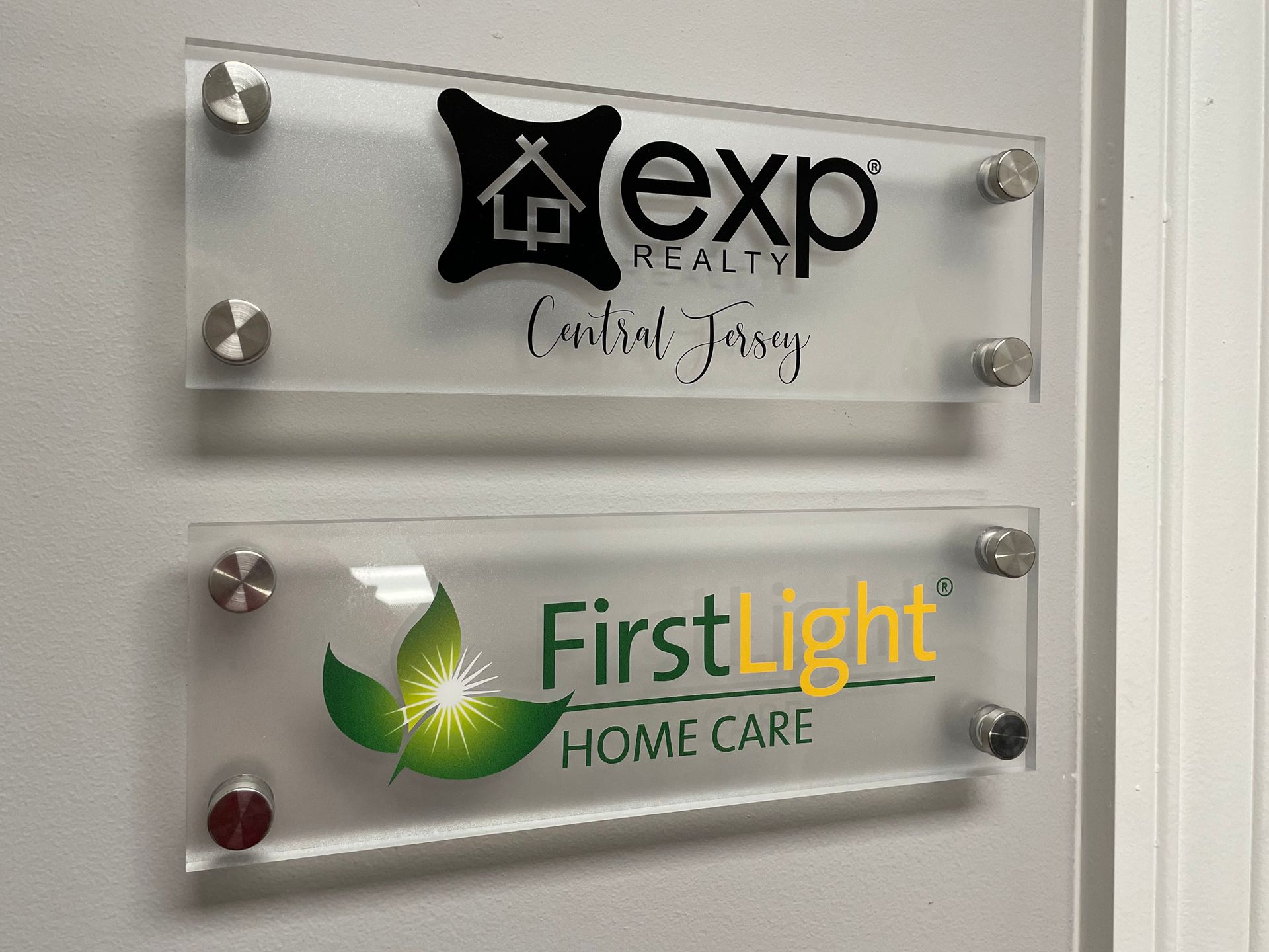 Two signs on a wall that say exp and first light home care