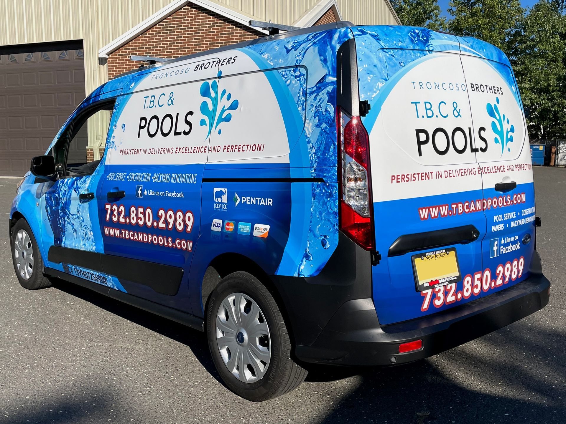 A t.b.c. pools van is parked in front of a building