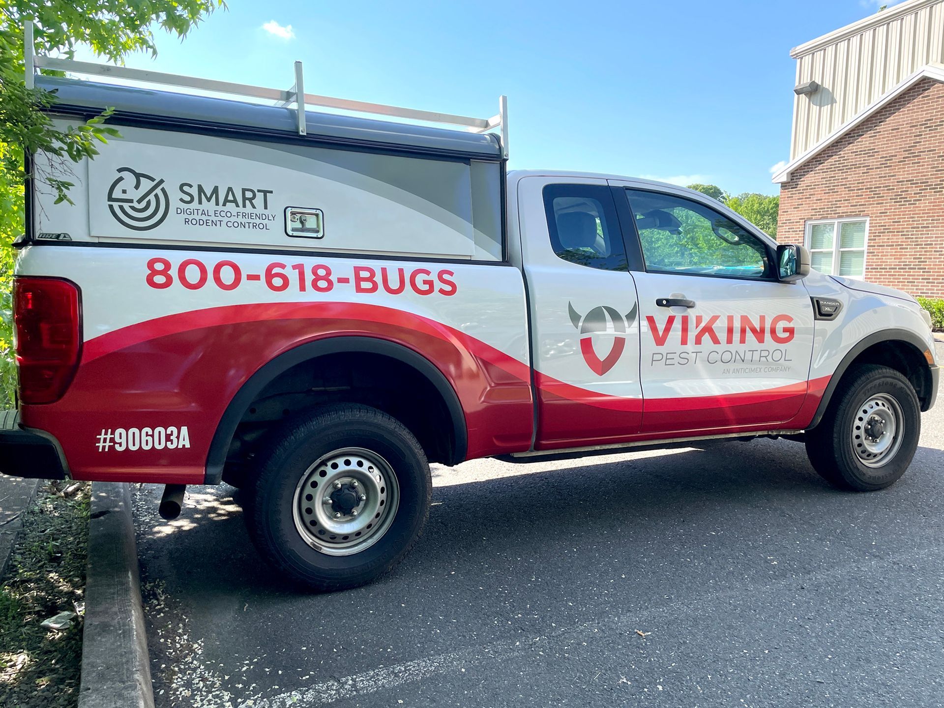 A red and white viking truck is parked on the side of the road.