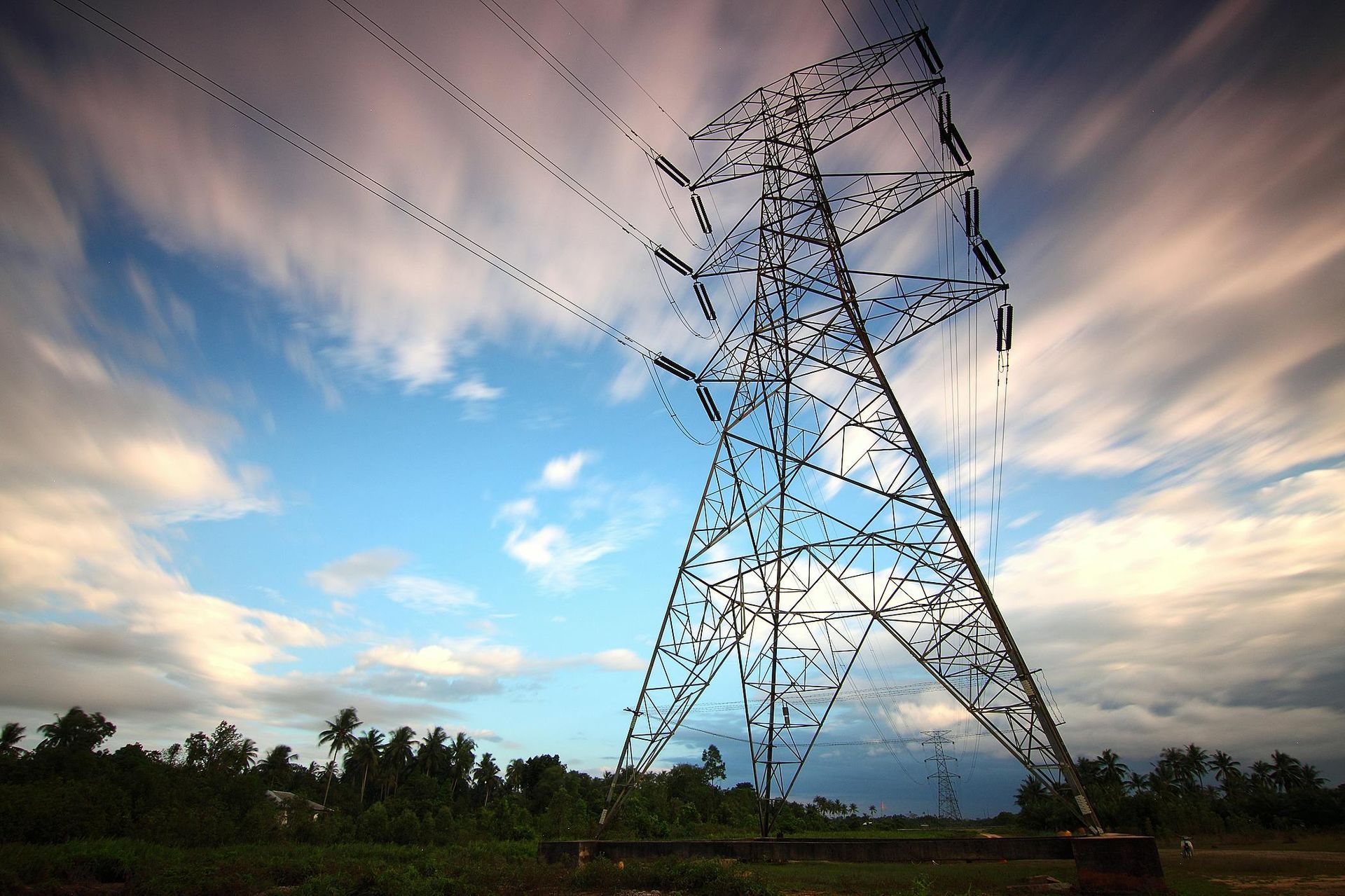 A power tower with a cloudy sky in the background