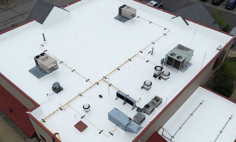 An aerial view of the roof of a building with a white roof.