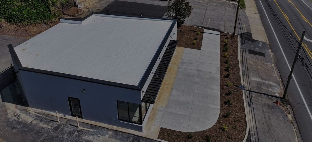 An aerial view of a building next to a road.