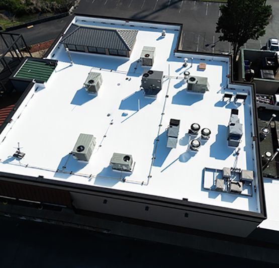 An aerial view of the roof of a building with a white roof.