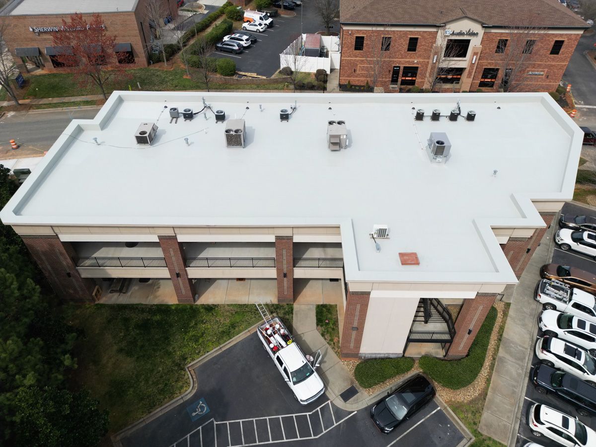 An aerial view of a building with a white roof.