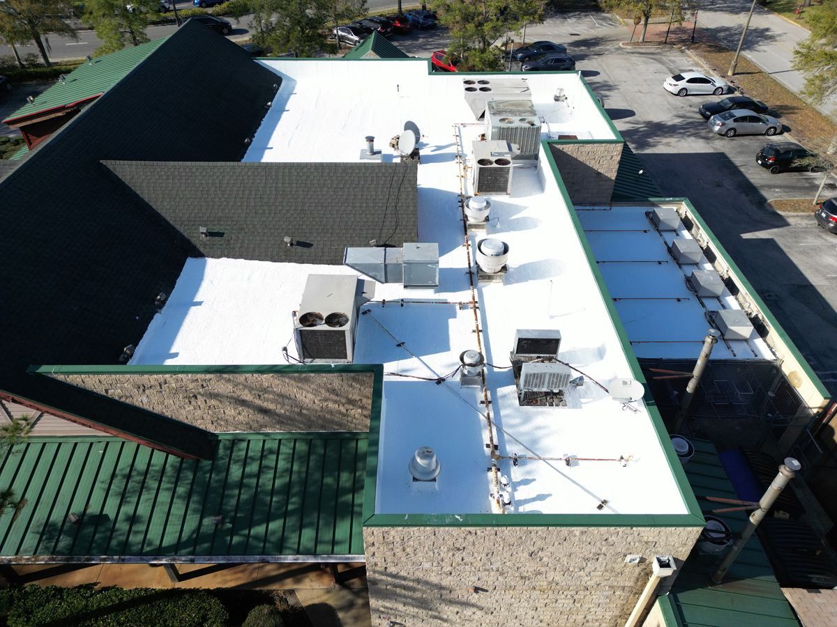 An aerial view of a building with a white roof