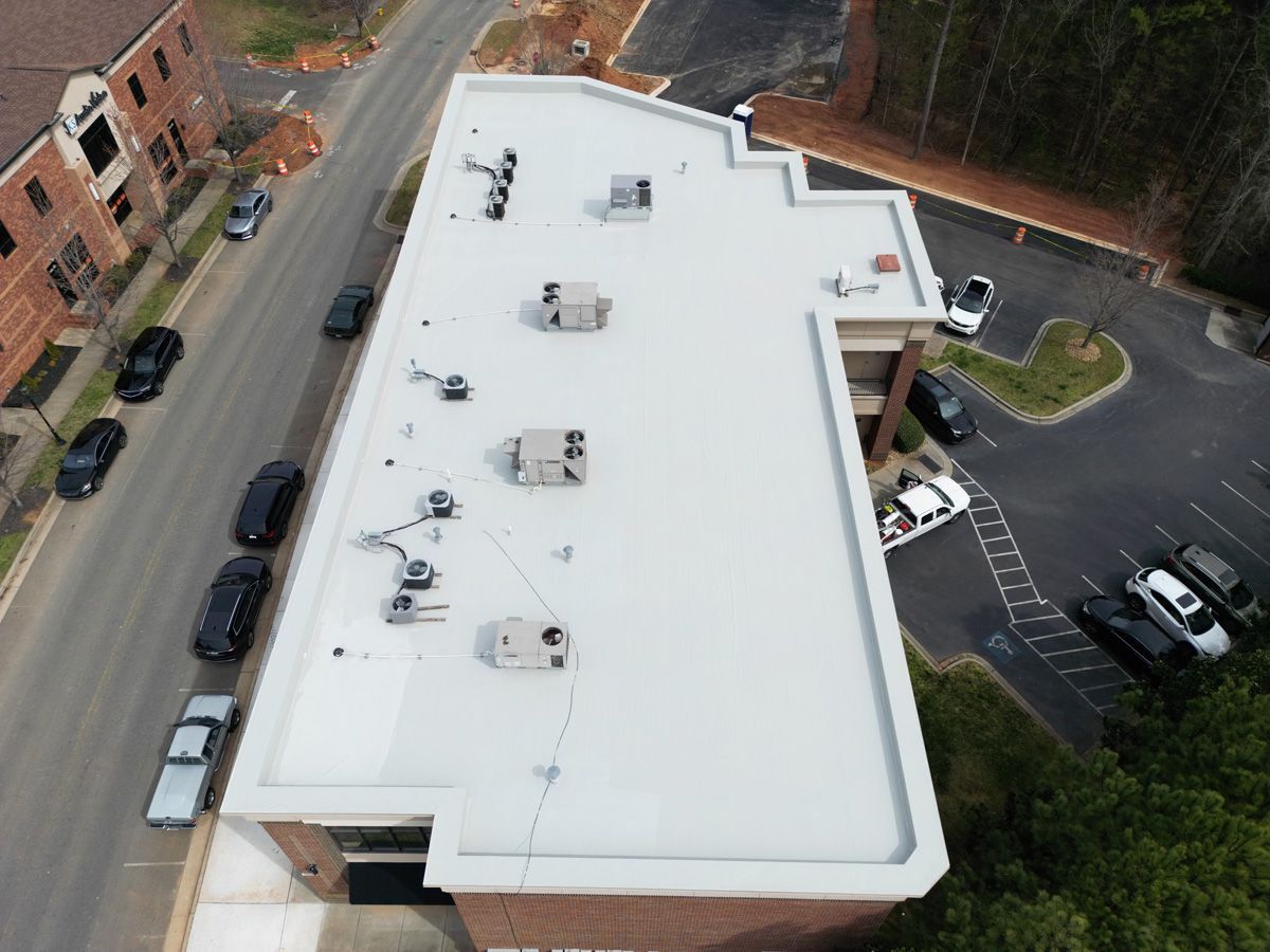 An aerial view of a building with a white roof