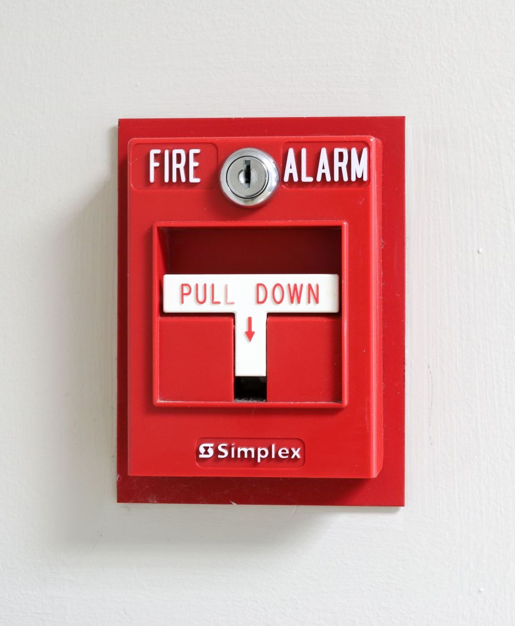 A simplex fire alarm with a pull down button