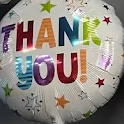 Colorful “THANK YOU!” balloon with confetti stars on a white background
