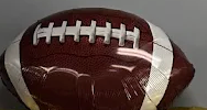 Brown football with white laces and stripes on a plain background