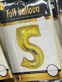 Gold foil balloon shaped like the number 5 in retail packaging