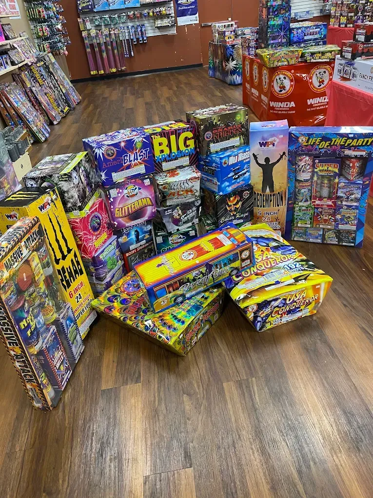 Store aisle with colorful fireworks and novelty pyrotechnics stacked on the floor and shelves
