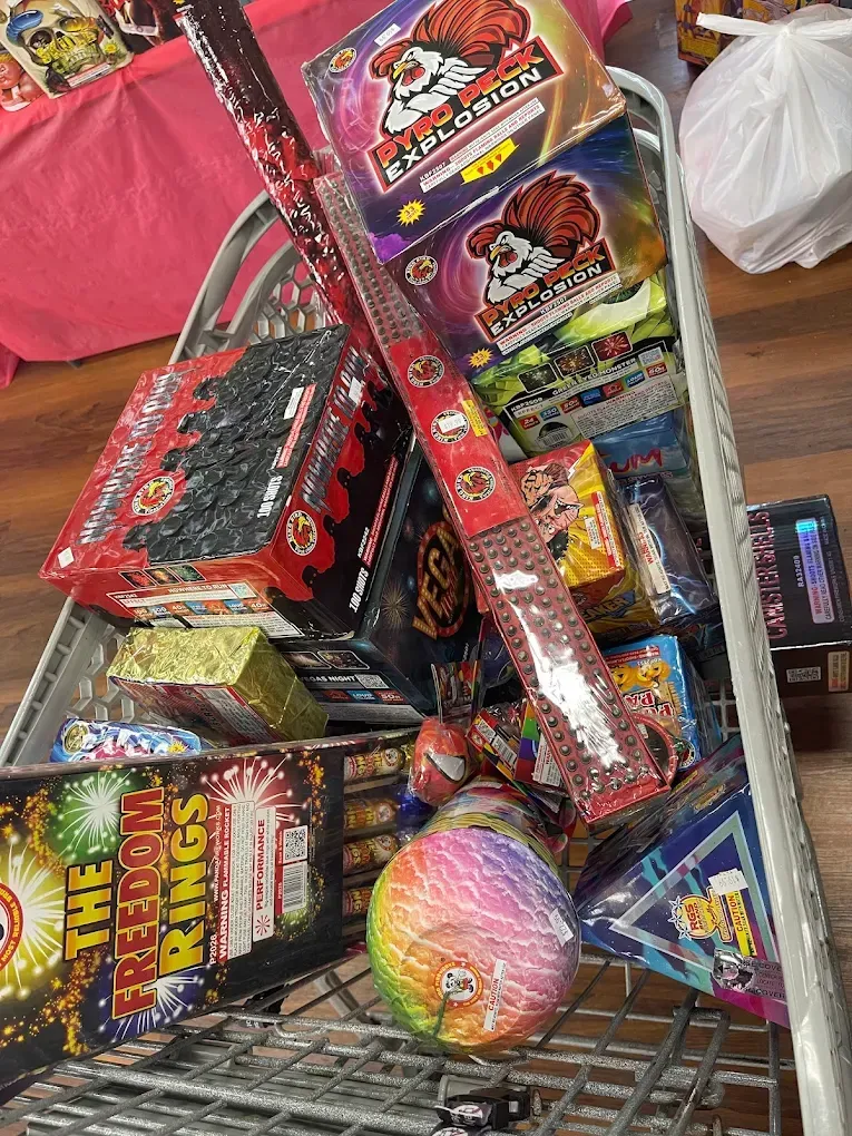 Pile of colorful fireworks and sparklers in retail packaging on a store floor