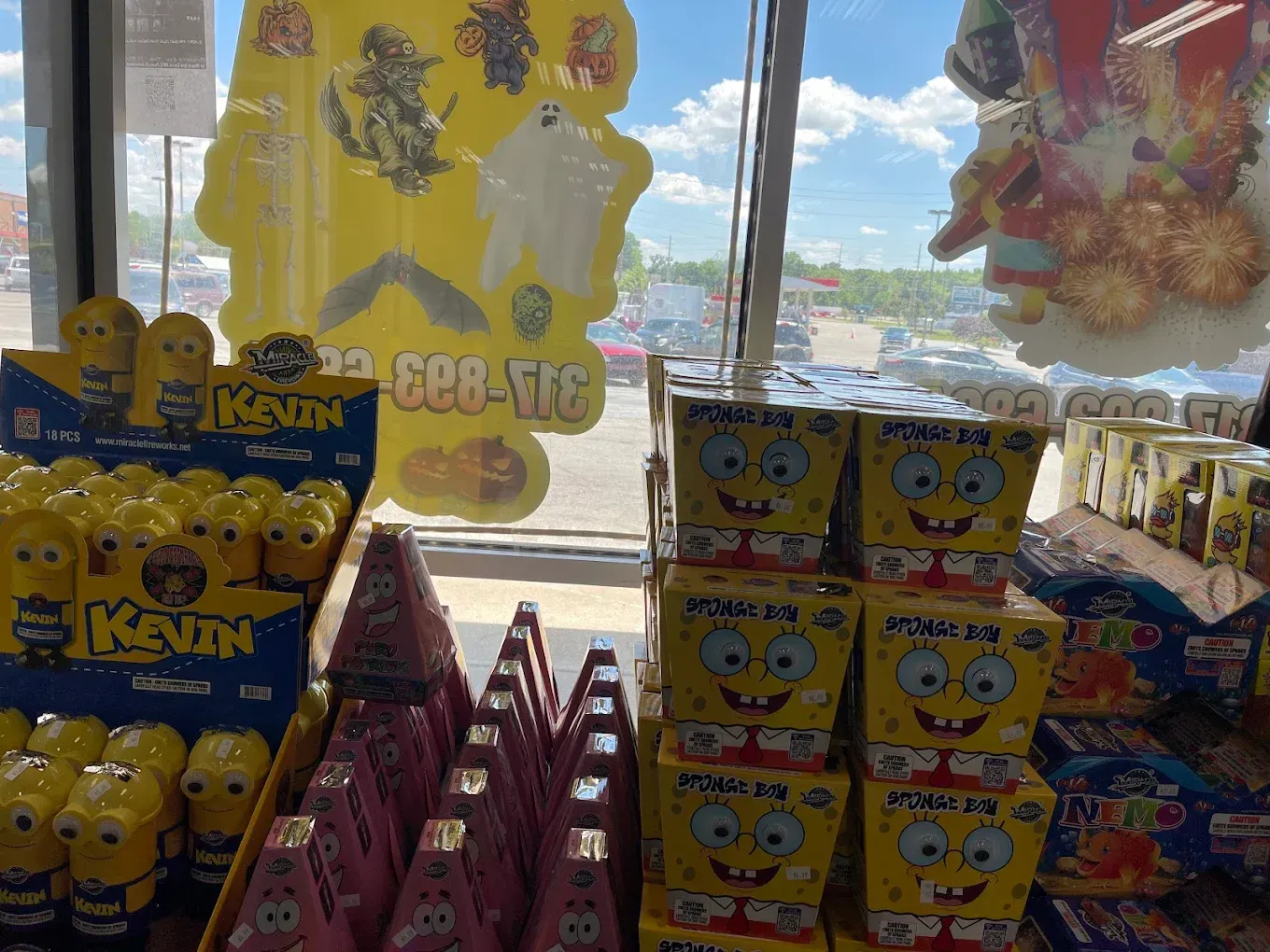 SpongeBob-themed candy display with yellow boxes, lollipops, and party favors in a store window