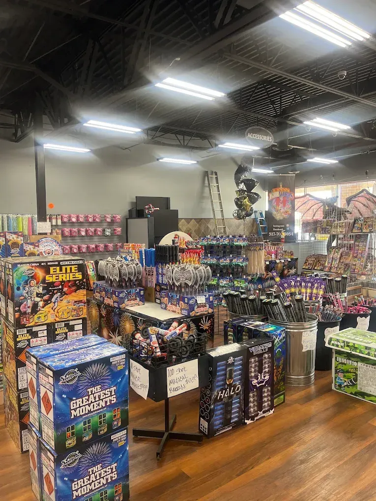 Indoor shop aisle with colorful candy and snack displays under bright ceiling lights.