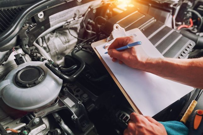 Writing Note on Top of Car Engine