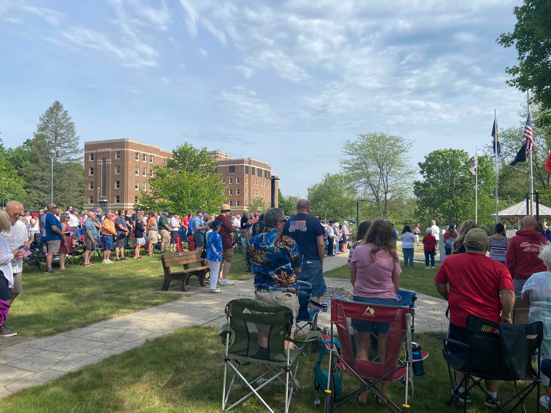 A large group of people are gathered in a park.